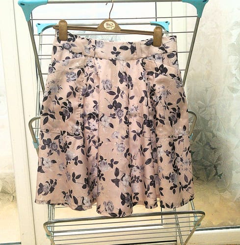 Reviewer's floral-patterned skirt made from Grey Floral Broderie Anglaise Polycotton Fabric, hanging on a drying rack.