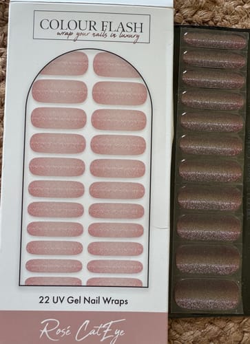 Customer's Rosé CatEye UV Gel packaging and sheet of 22 nail wraps on a textured background.