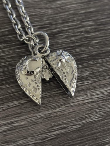 Customer's Cosmic Heart Pendant showing the sun and moon details on a silver chain.