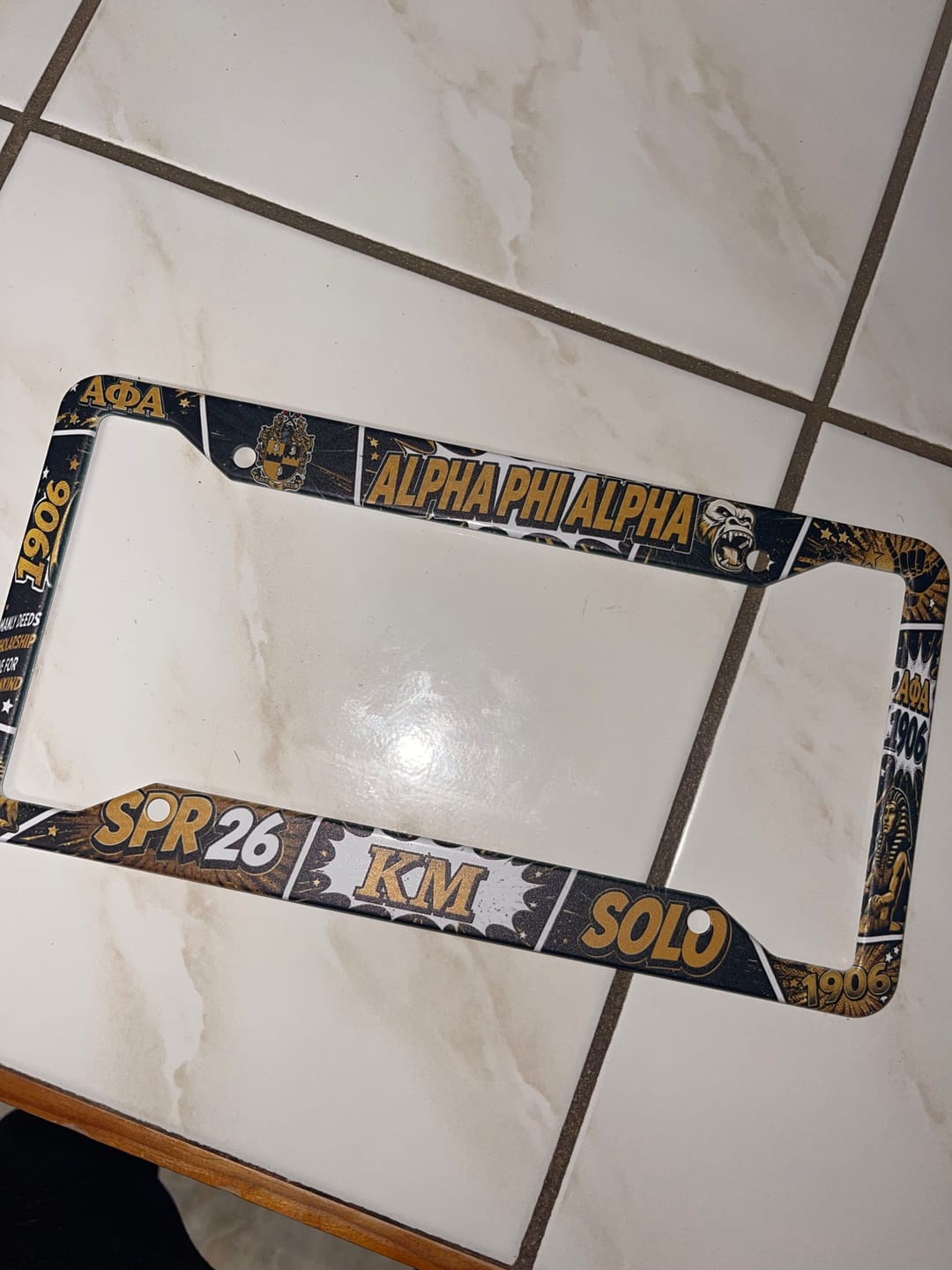 Customer photo review of Personalized Alpha Phi Alpha License Plate Frame Gold Pop Comic Style