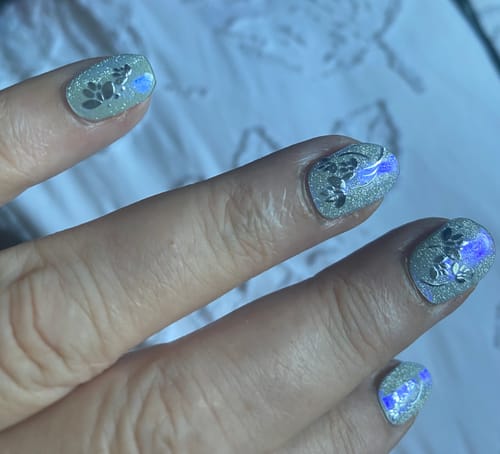 Customer's Glitter Ball nail wraps on hand with added silver floral stickers, showing a sparkly finish.