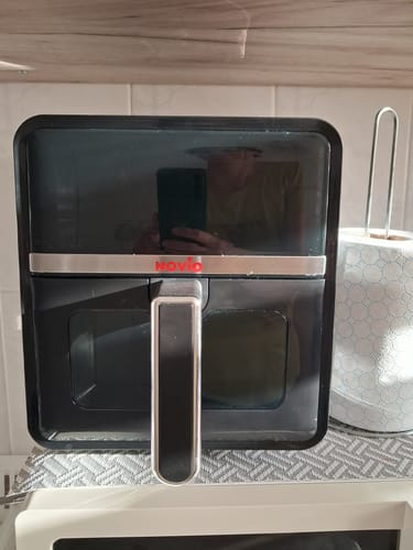 Customer's Novio StonePro air fryer in black, sitting on a kitchen counter next to a paper towel roll.