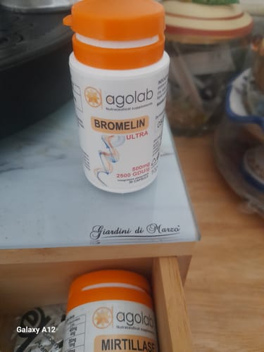 Customer's white and orange bottle of Bromelin Ultra standing on a surface with a bottle of Mirtillase in the drawer.