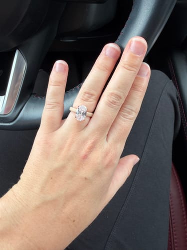 Customer's Rinfit Thin Silicone Ring featuring a nude band and oval-cut stone worn on a hand.