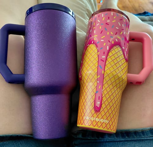 Customer's two Frost Buddy tumblers with handles, one purple glitter and one pink ice cream cone pattern.