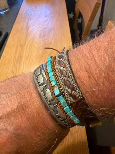 Customer's Bohemian Jasper Bracelet worn on wrist alongside several other stacked leather and metal bracelets.