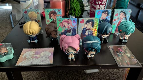 Customer's Alien Stage Anakt High School Series figures and holographic character cards displayed on a table
