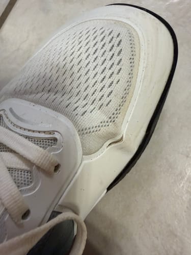 Customer's white CUURT Muuv court shoe with a wide toe box, close-up view.
