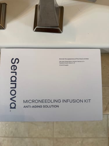 Reviewer's white Seranova Micro Infusion System box sitting on a bathroom counter.