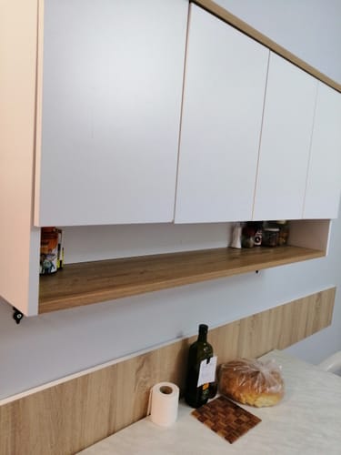 Customer's white and wooden Rani JE198 coffee corner wall cabinet installed in a kitchen with items on the shelf.