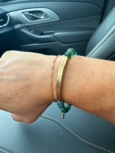 Customer's gold Twisted Accent Chain Bracelet worn on wrist alongside a beaded bracelet.