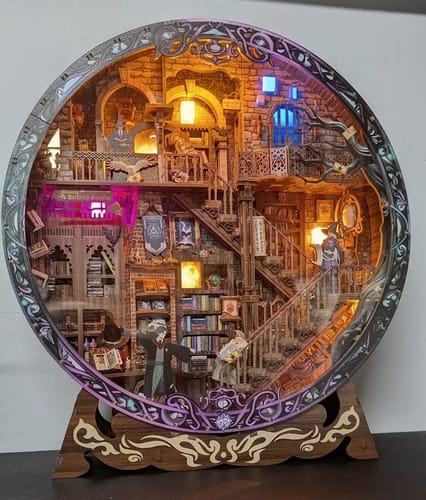 Customer's assembled Enchanted Globe DIY Book Nook with glowing lanterns, spiral staircases, and miniature books.