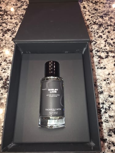 Customer's Shelby Lane eau de parfum glass bottle displayed in an open black gift box.