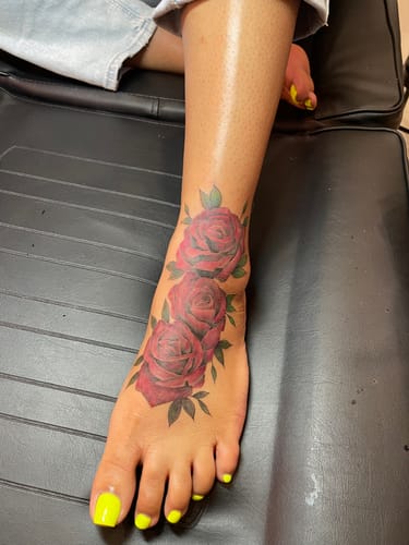 Customer's fresh rose tattoo on foot, numbed with XL Signature Tattoo Numbing Cream