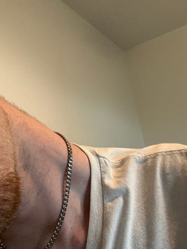 Customer's silver Mini Cuban Chain worn around a person's neck