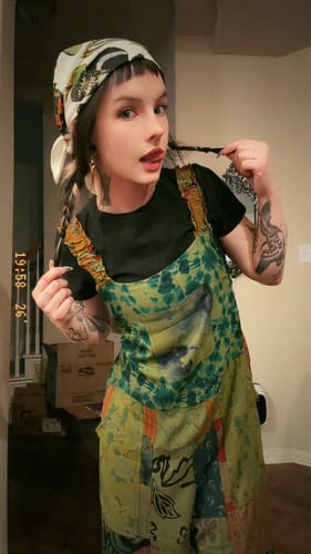 Customer's Pinned Bandana worn as a headscarf with butterfly prints, tied around a person's head.