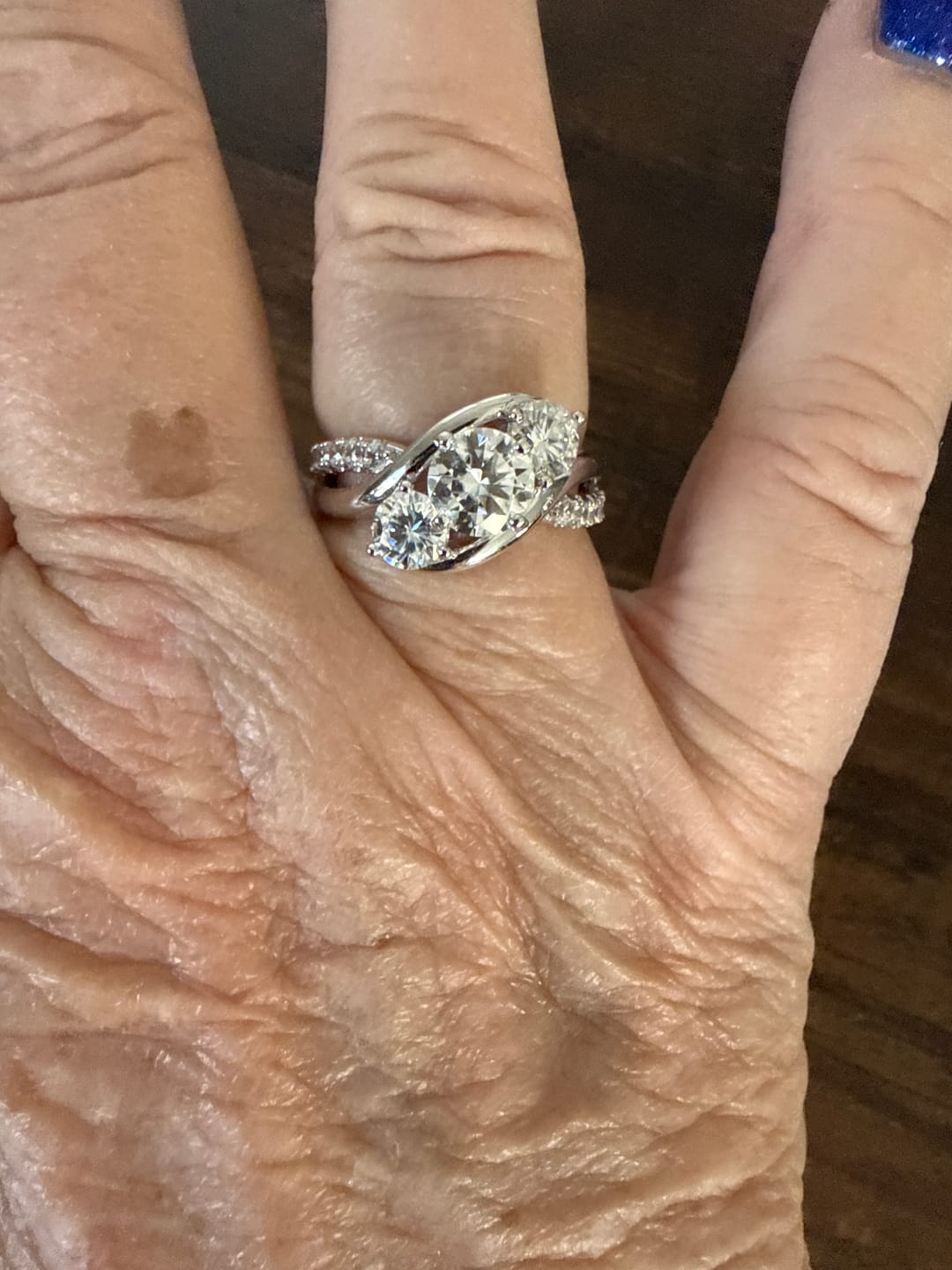 Customer photo review of Swirl Three Stone Moissanite Twisted Pave Engagement Ring
