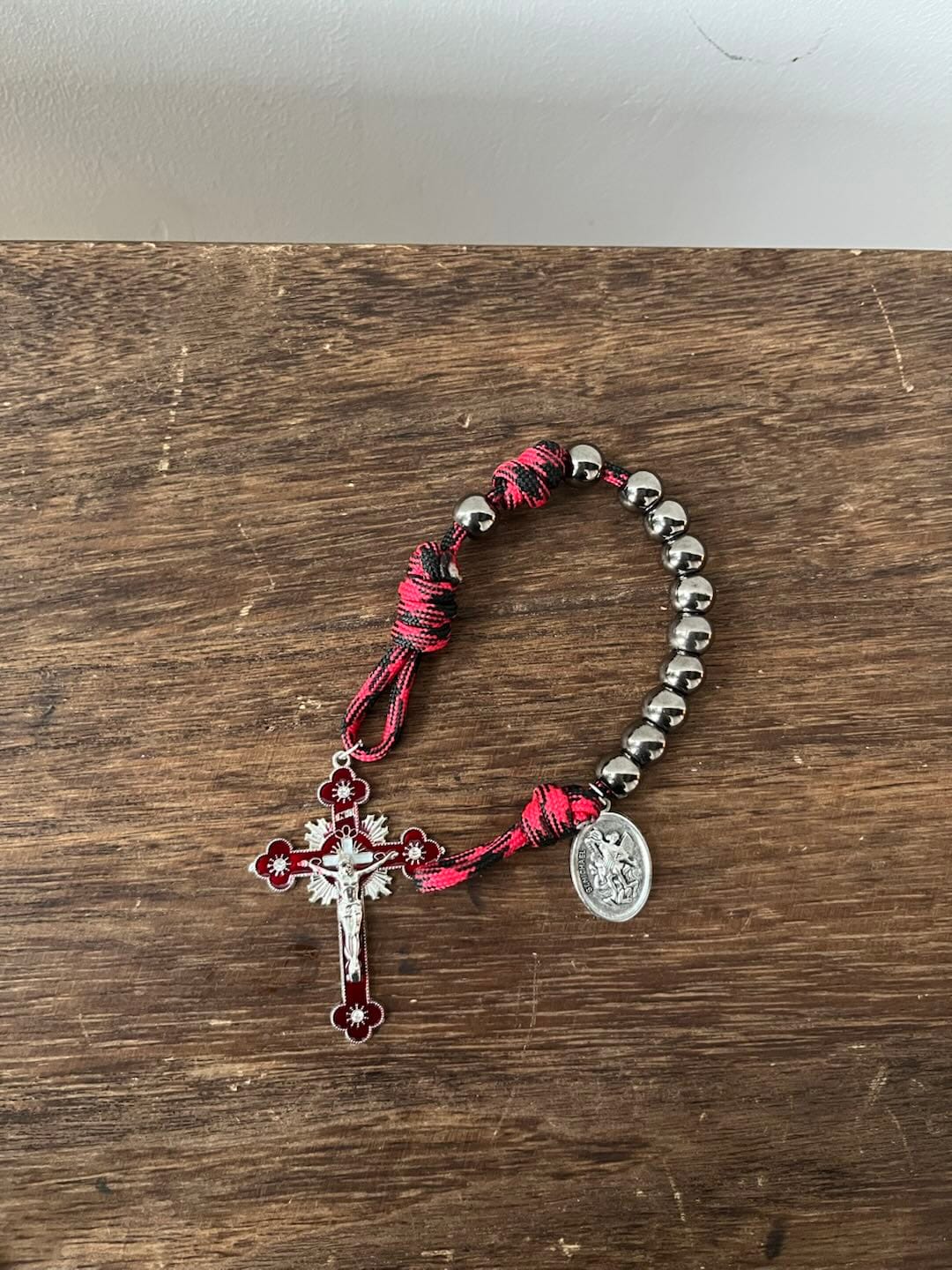 Customer photo review of Solacebeads Gunmetal Bead Car Rosary & Red Enamel Crucifix: Rooted In St. Michael Protection