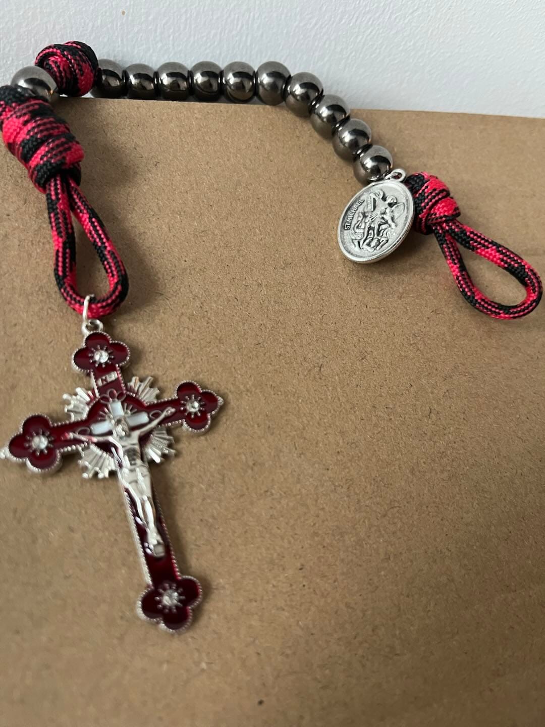 Customer photo review of Solacebeads Gunmetal Bead Car Rosary & Red Enamel Crucifix: Rooted In St. Michael Protection