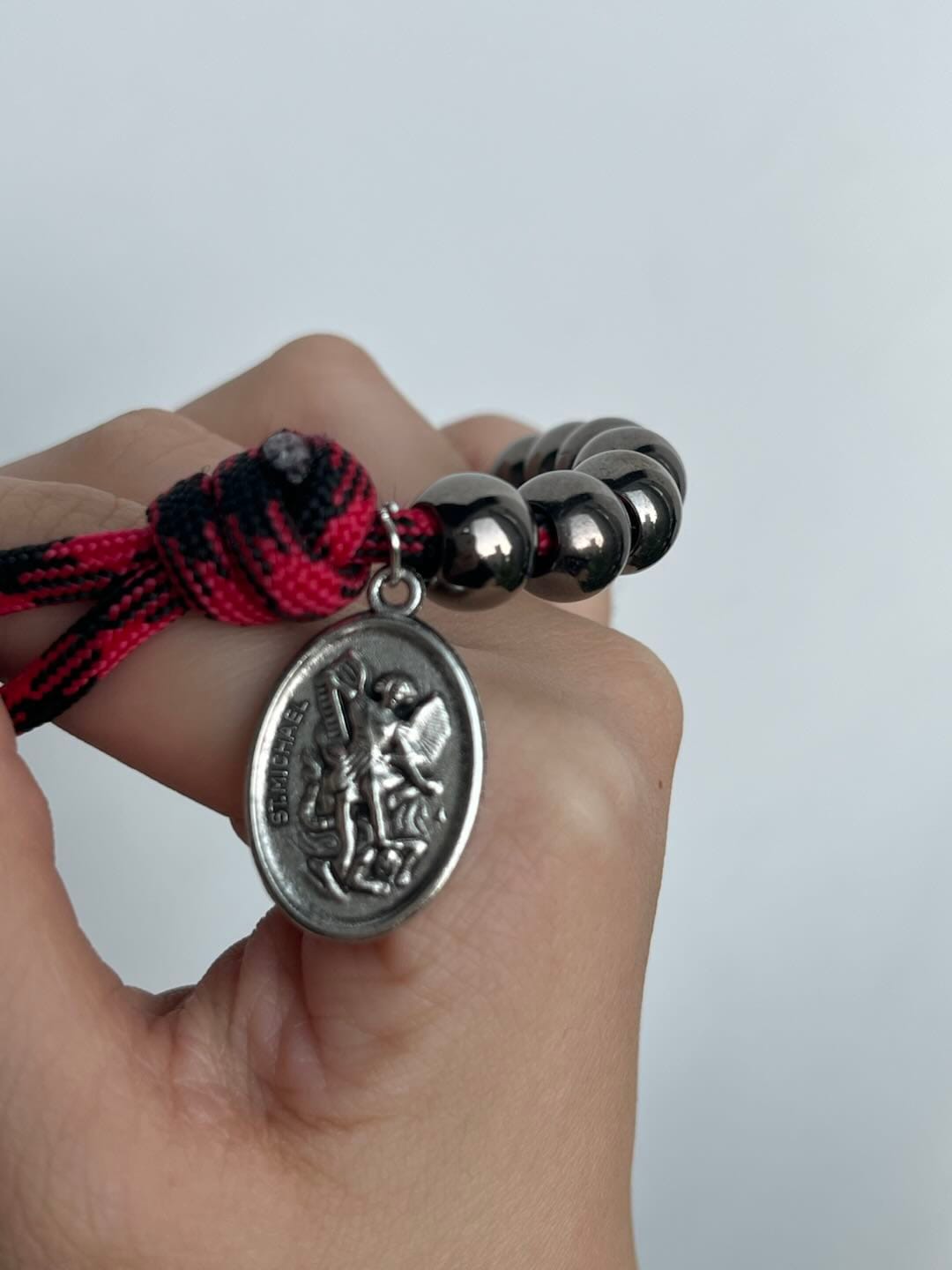 Customer photo review of Solacebeads Gunmetal Bead Car Rosary & Red Enamel Crucifix: Rooted In St. Michael Protection