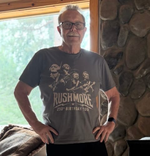 Customer's Rushmore Tour 250 T-shirt worn by a person, featuring a graphic of presidents playing musical instruments.