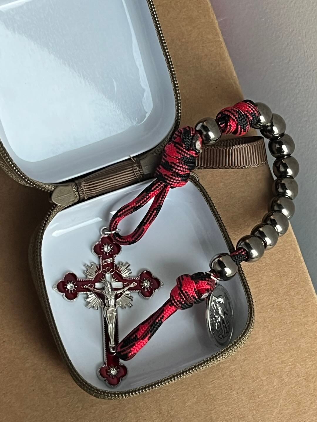 Customer photo review of Solacebeads Gunmetal Bead Car Rosary & Red Enamel Crucifix: Rooted In St. Michael Protection
