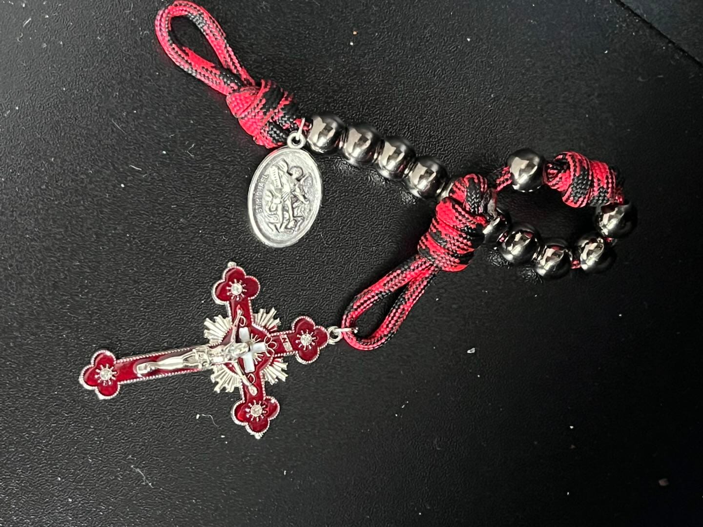 Customer photo review of Solacebeads Gunmetal Bead Car Rosary & Red Enamel Crucifix: Rooted In St. Michael Protection