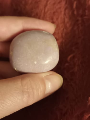 Customer's smooth, light purple Phosphosidérite stone held in a hand