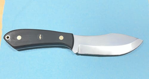 Reviewer's handmade knife, finished with EdgeCore Ceramic Grinding Belts, showing a smooth blade and black handle.