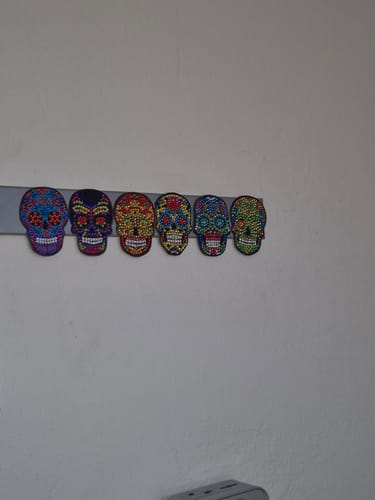 Customer's Diamond Painting Geschenk, six colorful skull designs arranged in a row on a wall.