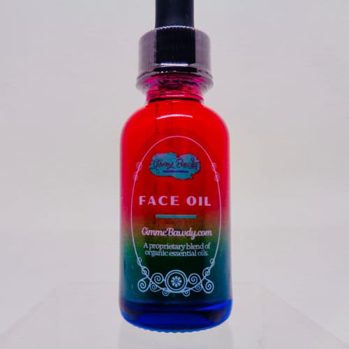 Customer's clear sticker on a vibrant, multi-colored face oil bottle.