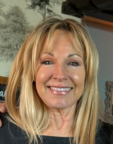 Reviewer smiling, showcasing healthy skin after using the Micro Infusion System.