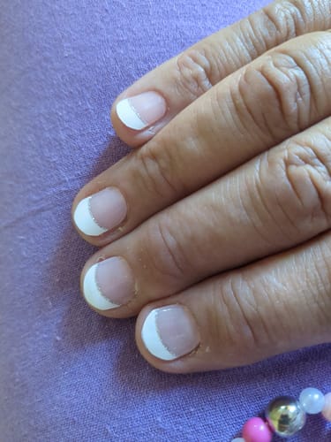 Customer's Classic French Tip Glitz gel nails applied to short, natural fingernails.