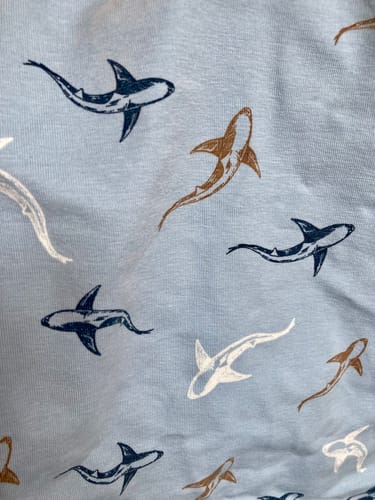 Customer's Shark Swim cotton jersey fabric, showing blue background with a shark pattern.