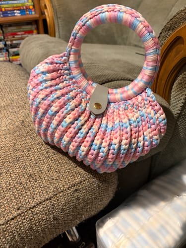 Customer's CrochetPark Shell crochet handbag in pastel pink and blue, featuring a rounded shell shape.