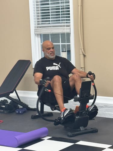 Customer's NovaRow RS3 rowing machine with a person using it to exercise in a home gym.