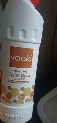 Customer's white Vooki Heavy Duty Toilet Bowl Cleaner bottle held by a hand.