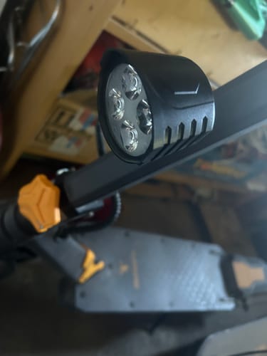 Customer's black circular headlight mounted on a scooter handlebar.