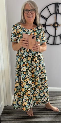 Customer's floral cotton poplin fabric sewn into a comfortable midi dress with blue, orange, and white flowers.