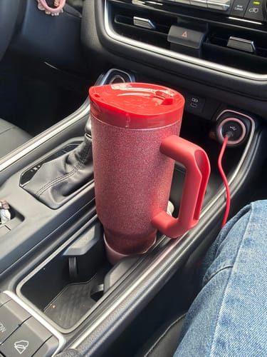Customer's dark red Thicc Buddy 40oz mug with a lid resting securely in a car cup holder.