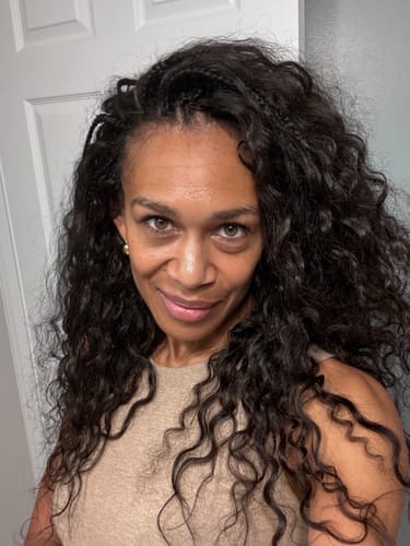 Customer's Feather Tips Pre-Looped Human Hair Crochet Braids styled as loose, dark, curly hair.
