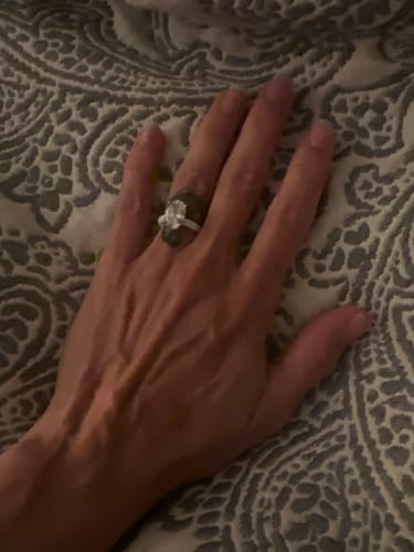 Customer's Rinfit silicone ring with a brilliant oval-cut stone worn on a hand.