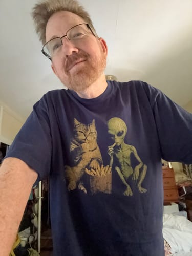 Customer's dark blue Close Encounters Premium shirt featuring a cat and alien graphic eating french fries.