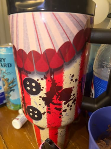 Reviewer's Creepshow Thicc Buddy mug with striped clown design and black handle, sitting on a desk.