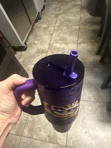 Customer's purple Thicc Buddy 40oz cup with a flip straw lid held in a hand