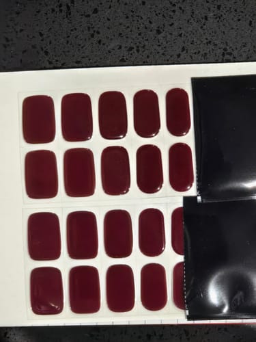 Customer's Bordeaux gel polish strips in dark red, showing two sheets of multiple nail applications.