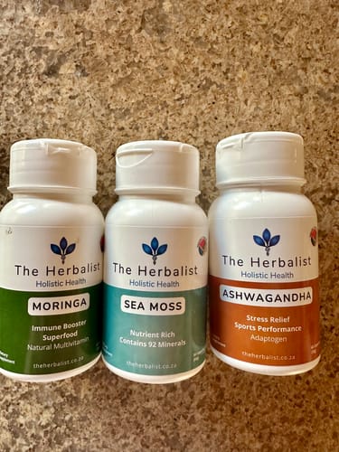 Customer's Reset Bundle, showing three The Herbalist bottles of Moringa, Sea Moss, and Ashwagandha on a stone counter.