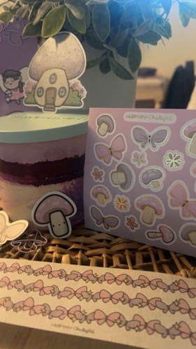 Customer's Sticker Subscription showing fairy garden stickers, a mushroom character sheet, and butterfly border tape.