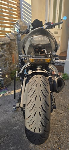 Customer's Locking Shim installed on a motorcycle, showing the license plate bracket in the upright position.