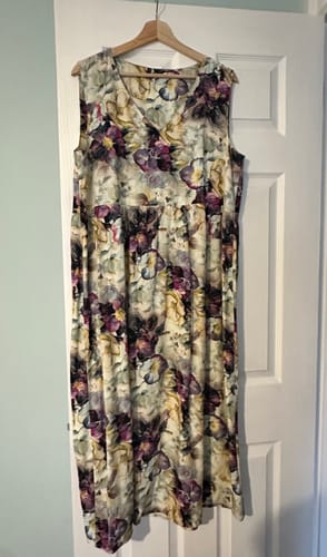 Customer's Whispering Petals dress made from floral viscose poplin fabric hanging on a door.